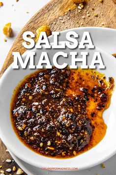 salsa macha in a white bowl on top of a wooden cutting board with the words salsa macha above it