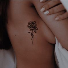 a woman with a rose tattoo on her chest