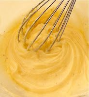 a whisk in a bowl filled with batter