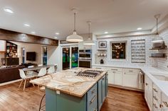 a large kitchen with an island in the middle and lots of counter space around it