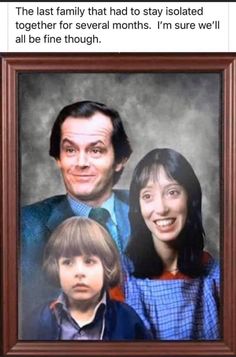 a man and woman are posing for a photo with two children in front of them