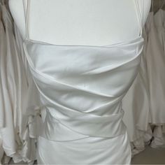 the back of a white wedding dress on display