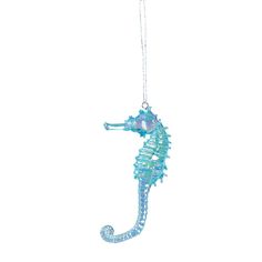 a blue seahorse ornament hanging from a chain on a white background,