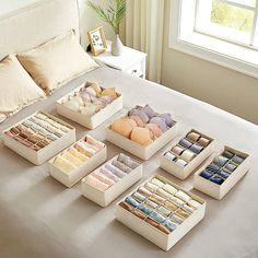 a bed with lots of drawers on top of it and a window in the background