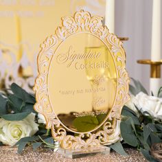 an award plaque sitting on top of a table next to white roses and greenery