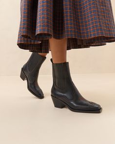 Mid-heel Western ankle boot in black vachetta leather. Features stetch gore panels, a padded leather footbed, a square toe, and contrast stitch details. Pulls on. 2.5-inch heel. Mid Heel Ankle Boots, Western Ankle Boots, Leather Western Boots, Western Boot, 5 Inch Heels, Mid Heel, Heeled Ankle Boots, Contrast Stitch, Western Boots