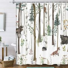 a shower curtain with animals and trees on it