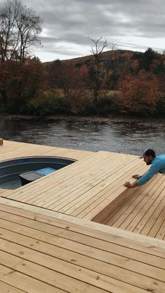 a man is doing yoga on a dock