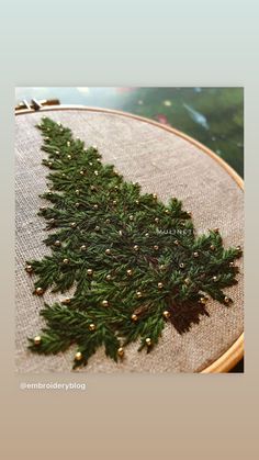 a close up of a cross stitch christmas tree