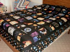 a bed with a space themed bedspread on it