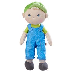 a small stuffed animal wearing overalls and a green cap on it's head