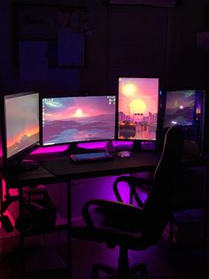 three computer monitors sitting next to each other on top of a desk in a dark room