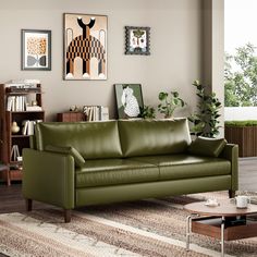 a living room with green leather furniture and pictures on the wall above it's fireplace