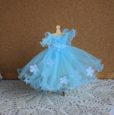 a dress made out of tulle with flowers on it