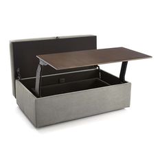 an open box with a table in it on a white background and the lid opened