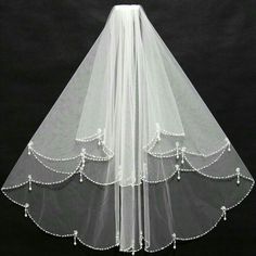 wedding veil with beaded trims and pearls on the bottom, in white color