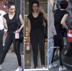 two women in black outfits and one is holding a pink cup