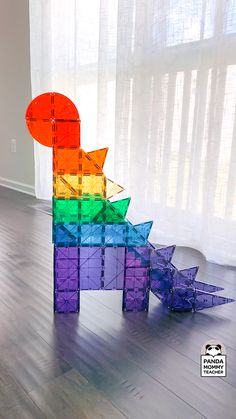 a colorful sculpture sitting on top of a hard wood floor