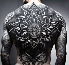 the back of a man with tattoos on his body and arms, all covered in intricate designs