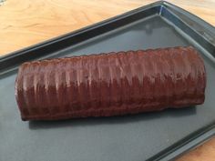 a large piece of food is on a baking sheet in the shape of a tube