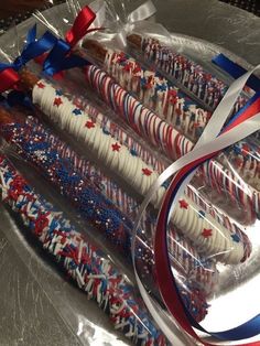 red, white and blue fireworks crackers in plastic wrappers on a silver platter