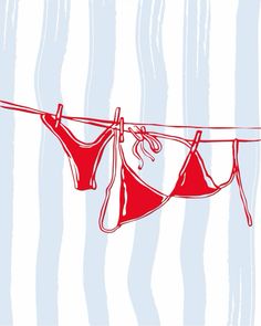 two red bikinis hanging on a clothes line