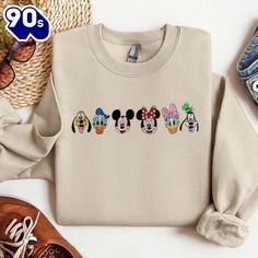 Mickey And Friends Embroidered Gildan Sweatshirt Introducing our Embroidered Sweatshirts – the perfect fusion of comfort and style. Crafted from premium, soft cotton-blend fabric, these sweatshirts are designed to keep you cozy while making a fashion statement. Each piece features intricate embroidery that adds a touch of elegance and individuality, elevating the classic sweatshirt into a standout wardrobe staple. Whether you’re lounging at home or heading out for a casual day, our embroidered sweatshirts offer a versatile and chic option. Available in a range of colors and designs, they make an ideal choice for those who appreciate quality craftsmanship and... Mickey Mouse Blanket, Classic Sweatshirt, Gildan Sweatshirts, Intricate Embroidery, Embroidered Sweatshirt, Mickey And Friends, Embroidered Sweatshirts, Embroidered Shirt, Embroidered Design