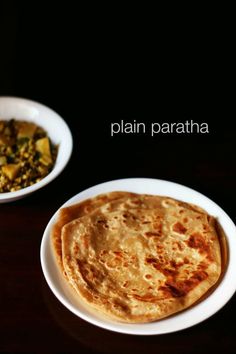 two white plates with food on them and the words plain paratha written in large letters