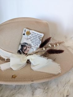 John Wayne "The Duke" Cowboy Playing card to add to your hat band for a custom hat. Accented with a 9mm Luger casing or  Winchester 45 !  Want to customize your favorite hat? Add a Hat band, Pin and Cowboy playing card for a custom look.  Add the boho dried flower cluster to this order, so easy just stick it in your hat band.  Update your favorite western hat.  The possibilities for a custom hat are endless!  Plenty of card options-- message me for more options!!   Looking for a different card let me know - I have a ton of them!!  These cards come with burnt corners and can be cut down to fit nicely in your hat band. Want help designing the perfect hat accessories?  Message me I would love to help build you a custom listing!    This order is for one cowboy playing card or one feather clust Creative Hats, Cowboy Hat Design, Western Hat, Flower Cluster, Western Hats, John Wayne, Cow Boy, Stick Pins, Playing Card