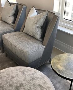 a living room with two couches and a coffee table in front of a window