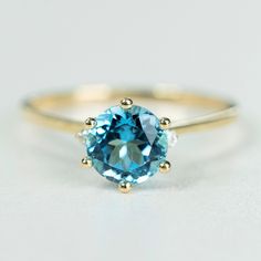 Valentine's gift: Swiss Blue Topaz engagement ring gold, ring for women. Gift for her Gemstone rings: 1ct Top quality Swiss Blue Topaz engagement ring, 100% 9k SOLID gold, gift for women, I have made this ring with a purpose of providing my customers who love high quality SOLID gold (No hollow no groove) with beautiful design. Stones we used to make this ring are highest grade DEF in 1ct moissanite for the main stone and 2pcs Moissanite diamonds. We intentionally designed to make this ring 100% Classic Round Topaz Birthstone Ring, Classic Topaz Birthstone Ring For Wedding, Classic Round Cut Topaz Birthstone Ring, Gold Diamond Ring With Blue Topaz In Round Cut, Classic 14k Gold Topaz Promise Ring, Classic Yellow Gold Topaz Promise Ring, Blue Diamond Promise Ring In 14k Gold, Yellow Gold Rings With Brilliant Cut Blue Topaz, Yellow Gold Blue Topaz Rings With Brilliant Cut