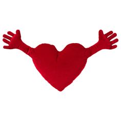 a red heart shaped pillow hanging from the ceiling with two hands on it's sides