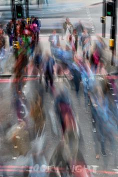 blurry photograph of people crossing the street