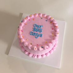 a pink cake with sprinkles and the words our 365 days on it