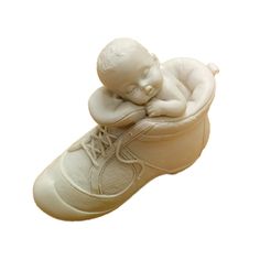 a baby sleeping on top of a shoe