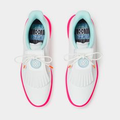 a pair of white and blue shoes with pink laces on the bottom, side view