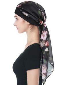 a woman wearing a black top with flowers on it and a scarf over her head