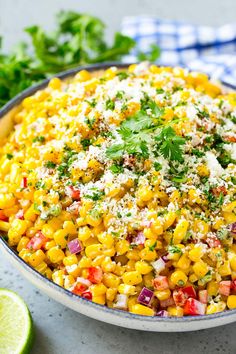 a bowl filled with corn and garnished with cilantro