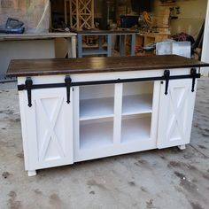 a kitchen island made out of an old barn door with sliding doors on the sides