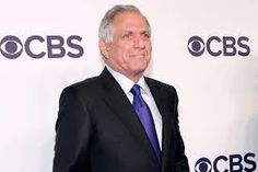 an older man in a suit and tie standing on a red carpet with the abc's logo behind him