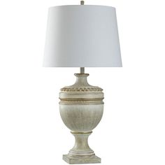 a white lamp with a beige shade on it