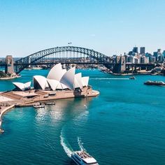 an aerial view of the sydney opera house and harbour bridge, with boats in the water