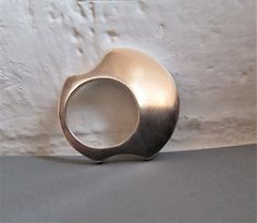 Modern Silver Ring is simple and strong.  Minimalistic Contemporary Ring is made of two circles. I had to saw on both sides, so that it gets comfortable between fingers. Art Ring Women is unique .  It is extremely rich Modern jewelry even without stones or embellishments, with its sumptuous silver surface. There is a traditional African jewelry vibe to it, even though it is a modern, minimalist ring.  On 5th photo, you can see a set of earrings matching the ring. They can be made by order, just Modern Silver Ring, Minimalist Flat, Wide Silver Ring, Earrings Matching, Hammered Silver Ring, Unique Brooch, Art Ring, Jewelry Minimalist, Hammered Rings