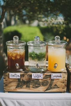 an image of the menu for a wedding with drinks in glass jars and labels on them