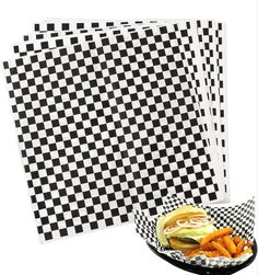 black and white checkerboard paper with fries on the plate next to it,