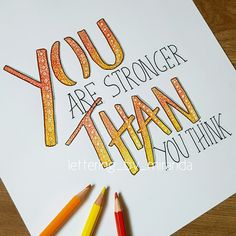 a card with the words you are strong and two colored pencils next to it