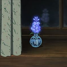 a blue vase with flowers in it sitting on a window sill