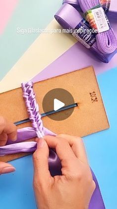 someone is working with crochet and yarn on a piece of crafting paper