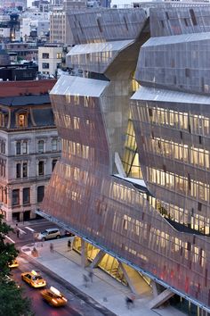 an aerial view of a large building with many windows and lights on it's sides