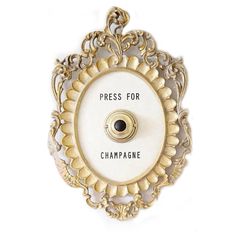 a white and gold clock with the words press for champagne on it's face